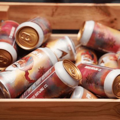 Beer cans with colorful labels in a wooden crate